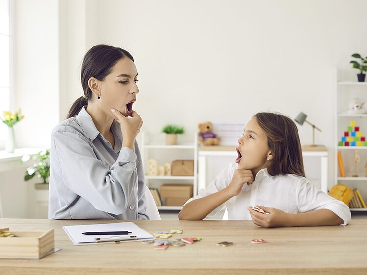 Speech therapist and child practicing sound production during articulation therapy at Optimum Speech in Apple Valley, CA